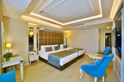 a hotel room with a bed and a table and chairs at Büke Hotel Şişli in Istanbul