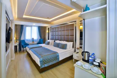 a bedroom with a large bed in a room at Büke Hotel Şişli in Istanbul