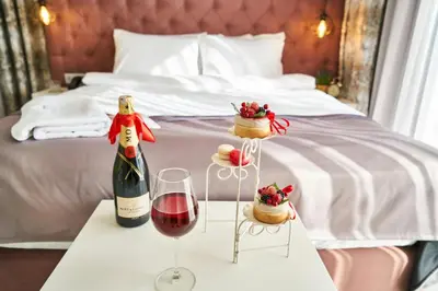 a table with a bottle of wine and two glasses at Büke Hotel Şişli in Istanbul