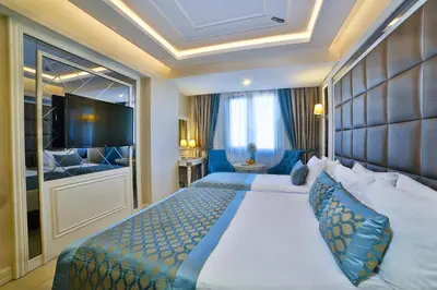 a hotel room with two beds and a television at Büke Hotel Şişli in Istanbul