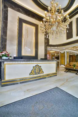 a large lobby with a chandelier and a reception desk at Büke Hotel Şişli in Istanbul