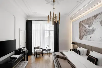 a bedroom with a large bed and a chandelier at AKKA Lush Hotel Taksim in Istanbul