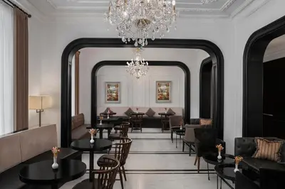 a dining room with tables and chairs and a chandelier at AKKA Lush Hotel Taksim in Istanbul