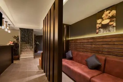 a lobby with a brown couch in a room at AKKA Lush Hotel Taksim in Istanbul