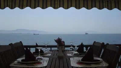 a table with a view of the ocean at Atamer Doga Resort in Gemlik