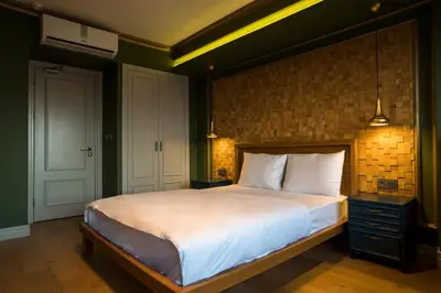a bedroom with a large bed and a brick wall at Sublime Porte Hotel in Istanbul