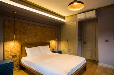 a bedroom with a white bed with a brick wall at Sublime Porte Hotel in Istanbul