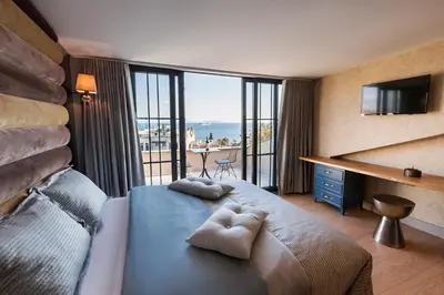 a bedroom with a large bed with a view of the ocean at Sublime Porte Hotel in Istanbul