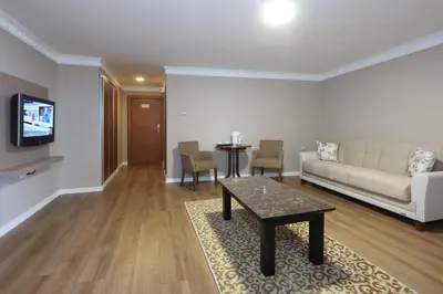 a living room with a couch and a table at Balturk Hotel Sakarya in Sakarya