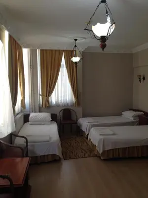 a hotel room with two beds and a window at Hotel Atasayan in Gebze