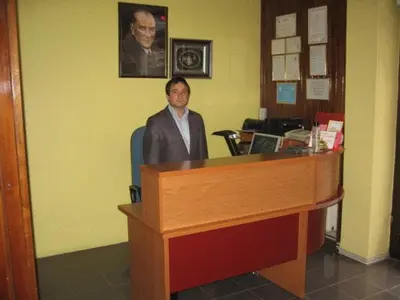 a man sitting at a desk in a office at Hotel Atasayan in Gebze