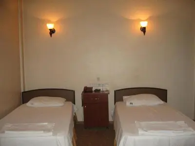 two beds in a room with lights on the wall at Hotel Atasayan in Gebze