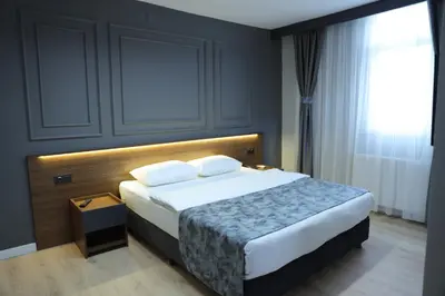 a bedroom with a large bed and a window at Turkuaz Hotel in Gebze