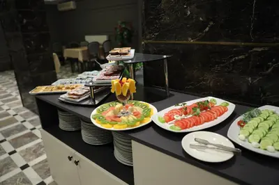a buffet with plates of food on a table at Turkuaz Hotel in Gebze