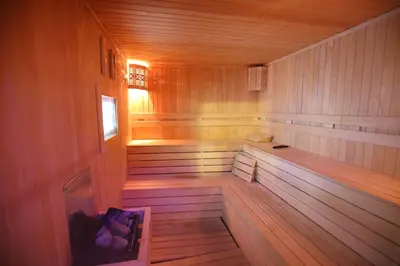 a large wooden sauna with a bench in it at Seckin Hotel in Sakarya