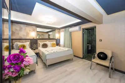 a bedroom with a bed and flowers in a room at Grand Ons Hotel in Istanbul