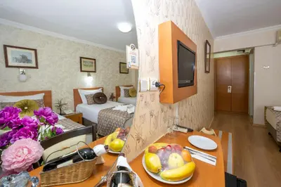 a hotel room with a table and a living room at Grand Ons Hotel in Istanbul