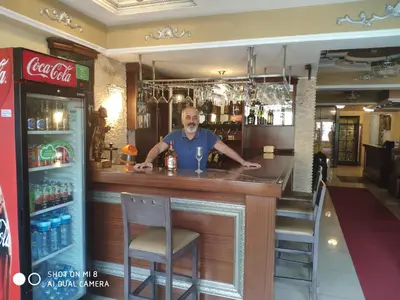 a man standing at a bar in a restaurant at Hotel Bazaar in Istanbul