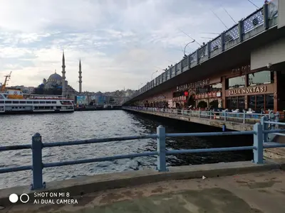 a bridge over a river with a mosque in the background at Hotel Bazaar in Istanbul