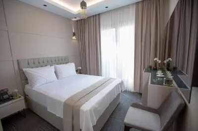 a bedroom with a white bed and a window at Anatolia Inn in Istanbul