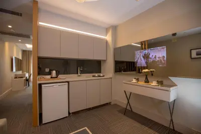 a kitchen with white cabinets and a counter top at Anatolia Inn in Istanbul