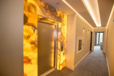 a hallway with a yellow wall with a door at Anatolia Inn in Istanbul