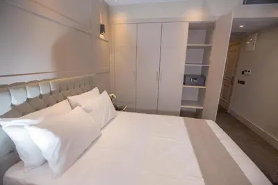 a bedroom with a large white bed with white pillows at Anatolia Inn in Istanbul