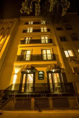 a tall yellow building with lit windows at night at Anatolia Inn in Istanbul