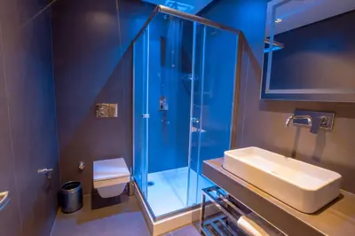 a bathroom with a sink and a glass shower at Anatolia Inn in Istanbul