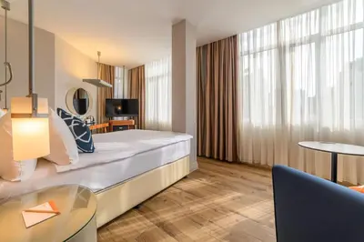 a hotel room with a large bed and a table at Four Points Flex by Sheraton Istanbul Taksim Square in Istanbul