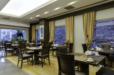 a restaurant with tables and chairs and windows at Levni Hotel & SPA - Special Category in Istanbul