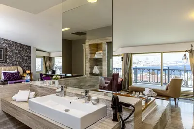 a bathroom with a sink and a living room at Levni Hotel & SPA - Special Category in Istanbul
