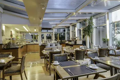 a restaurant with tables and chairs and a kitchen at Levni Hotel & SPA - Special Category in Istanbul