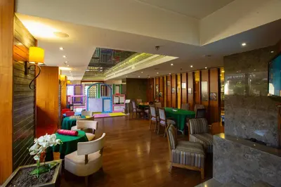 a restaurant with green tables and chairs in a room at Marigold Thermal & Spa Hotel Bursa in Bursa