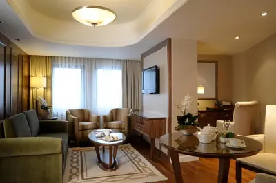 a room with a living room with a table and a living room at Marigold Thermal & Spa Hotel Bursa in Bursa