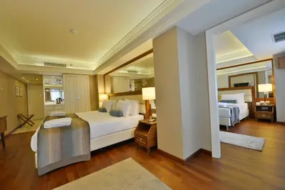 a bedroom with two beds and a large mirror at Marigold Thermal & Spa Hotel Bursa in Bursa