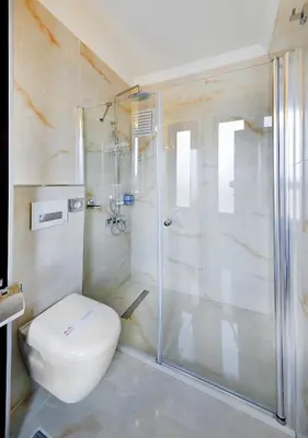 a bathroom with a toilet and a glass shower at Sidonya Hotel in Istanbul