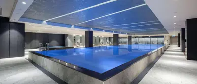a large blue swimming pool in a building at Hilton Istanbul Bakirkoy in Istanbul