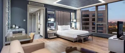 a bedroom with a bed and a living room at Hilton Istanbul Bakirkoy in Istanbul