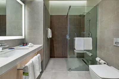 a bathroom with a shower and a toilet and a sink at Hyatt House Gebze in Gebze
