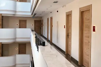 a hallway of a hospital with wooden doors at Ramada Encore By Wyndham Istanbul Basin Express in Istanbul