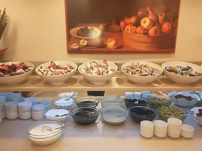 a shelf with bowls of food and bowls of fruit at Hotel Süreyya in Istanbul
