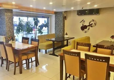 a dining room with tables and chairs in a restaurant at Hotel Süreyya in Istanbul
