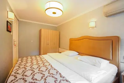 a bedroom with a large bed with a wooden headboard at Authentic Apartments OldCity in Istanbul