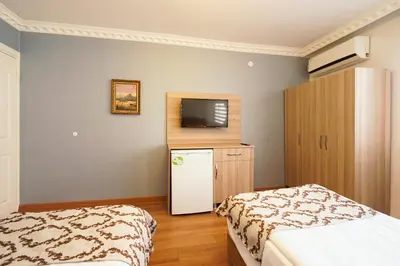 a room with a bed and a refrigerator and a tv at Authentic Apartments OldCity in Istanbul