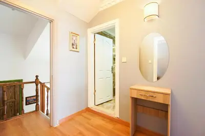a hallway with a mirror and a wooden table at Authentic Apartments OldCity in Istanbul