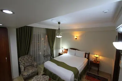 a hotel room with a bed and a chair at Basileus Hotel in Istanbul
