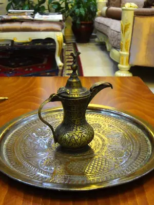 a vase sitting on a plate on a table at Basileus Hotel in Istanbul
