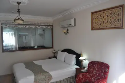a hotel room with a bed and a chair at Basileus Hotel in Istanbul
