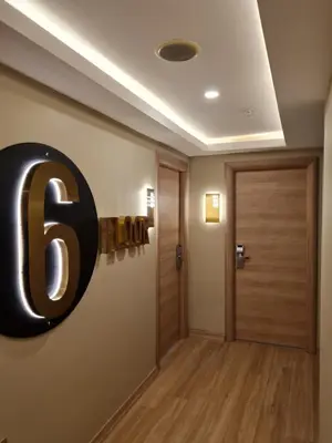 a room with a large number six sign on the wall at Air Boss Istanbul Airport and Fair Hotel in Istanbul